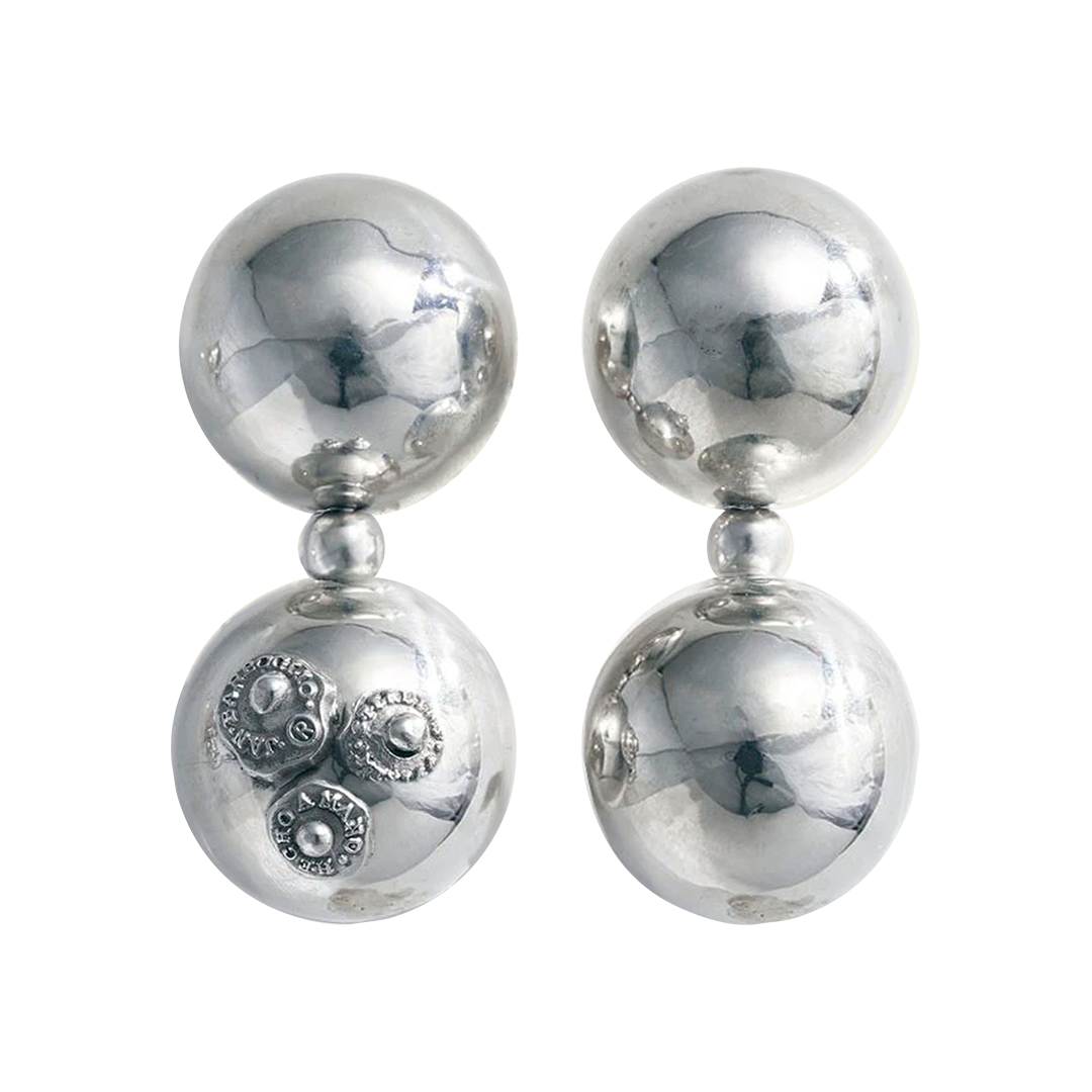 Two earrings with two silver spheres and a small one between each sphere. One earring has three signature seals engraved.
