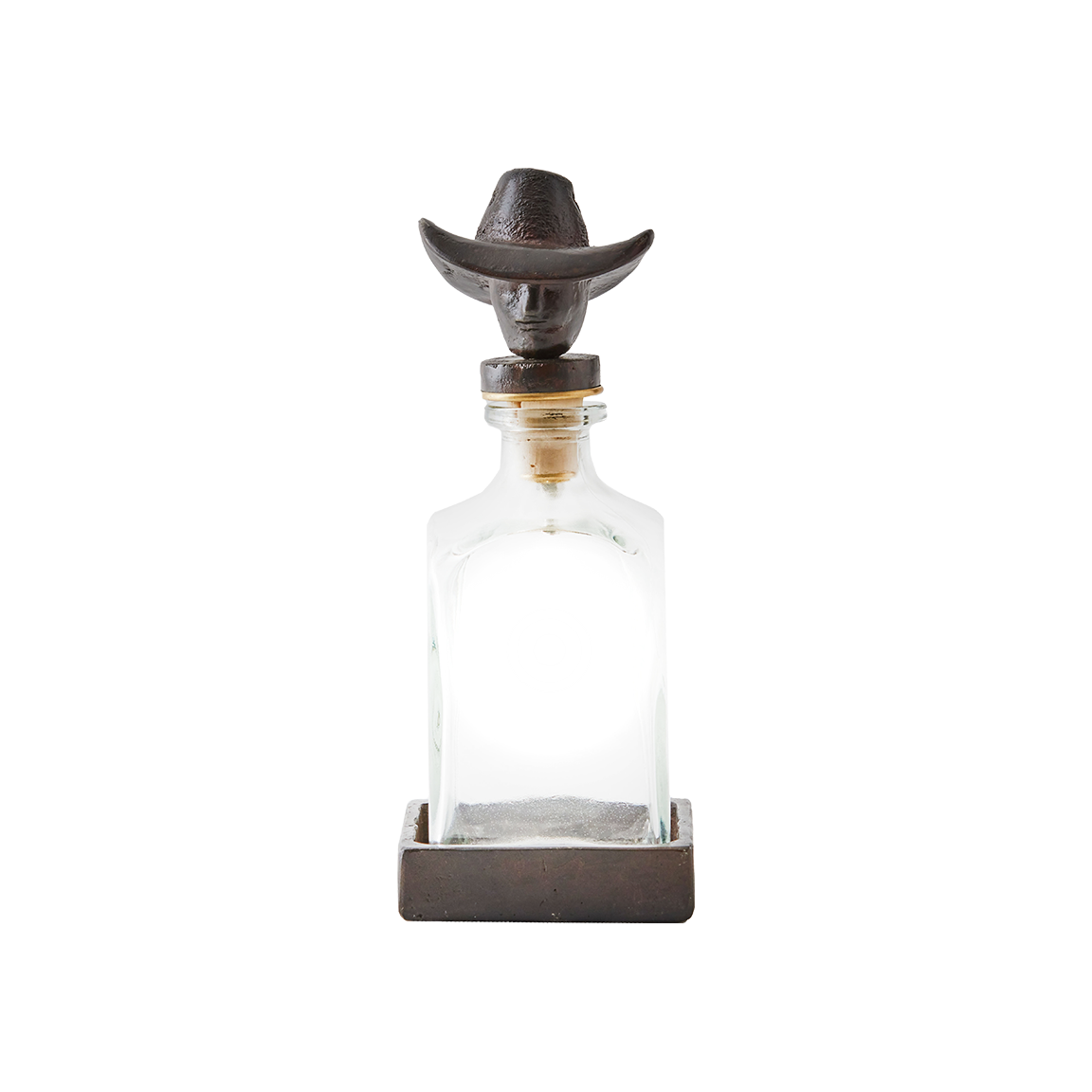 A cowboy iron decanter topper with vintage style glass bottle and iron coaster.