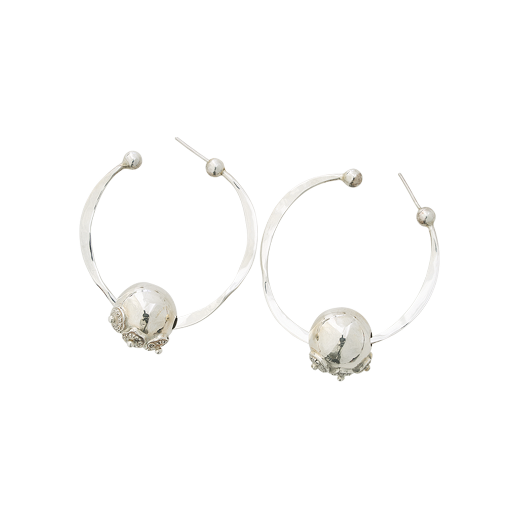 Two silver hoop earrings with a bead in the middle of each hoop. Each bead has three engraved seals. Plain background.