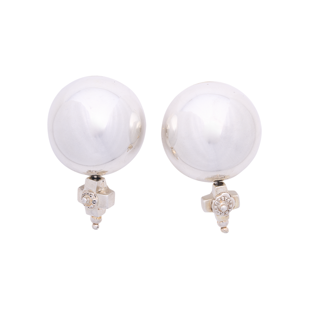 Two silver circle earrings with a silver cross under each sphere.