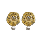 Gold and silver almost circular earrings with a seal that includes the designer's name. A small ball is under the seals and another one is in the center of the seal.