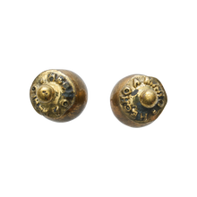 Two bronze studs with an engraved seal and a small bronze ball in the center.