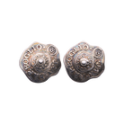 Old silver wavy circle earrings with  the name of the designer and where they were made. In the center is a silver bead.