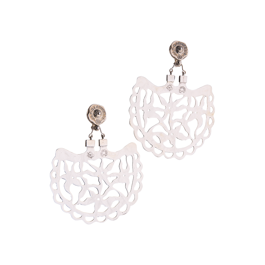 Sterling silver earrings resemble an open fan in shape with an intricate pattern resembling stars. On top of the intricate pattern is a seal with the designer's name.