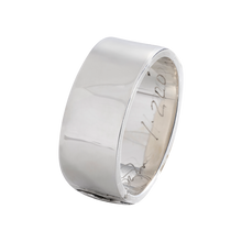 A silver bracelet with a signature engraved inside.