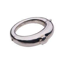 A silver bracelet featuring a cross. 