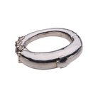 A silver bracelet featuring a cross and three seals with the designer name on the left.