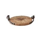 A rough-hewn round cutting board with cast iron bird handles.