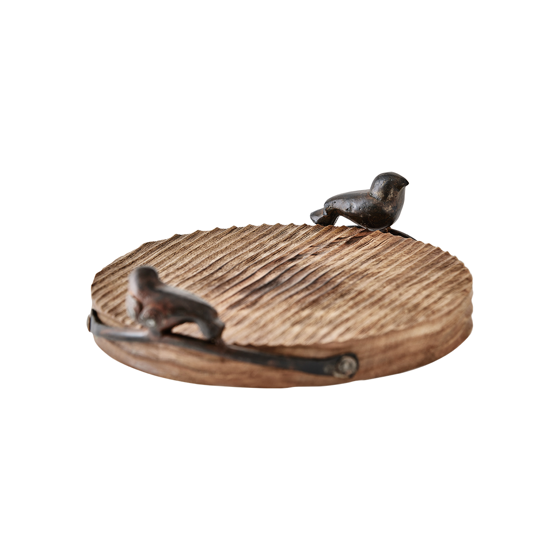 A  round wood  cutting board with cast iron bird handles.