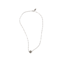 A delicate silver chain necklace with a silver cross.