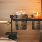 Two lit candles inside a glass.