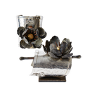 Two silver cuffs with a dark metal rose. One cuff shows the front view and the other shows the side view. 