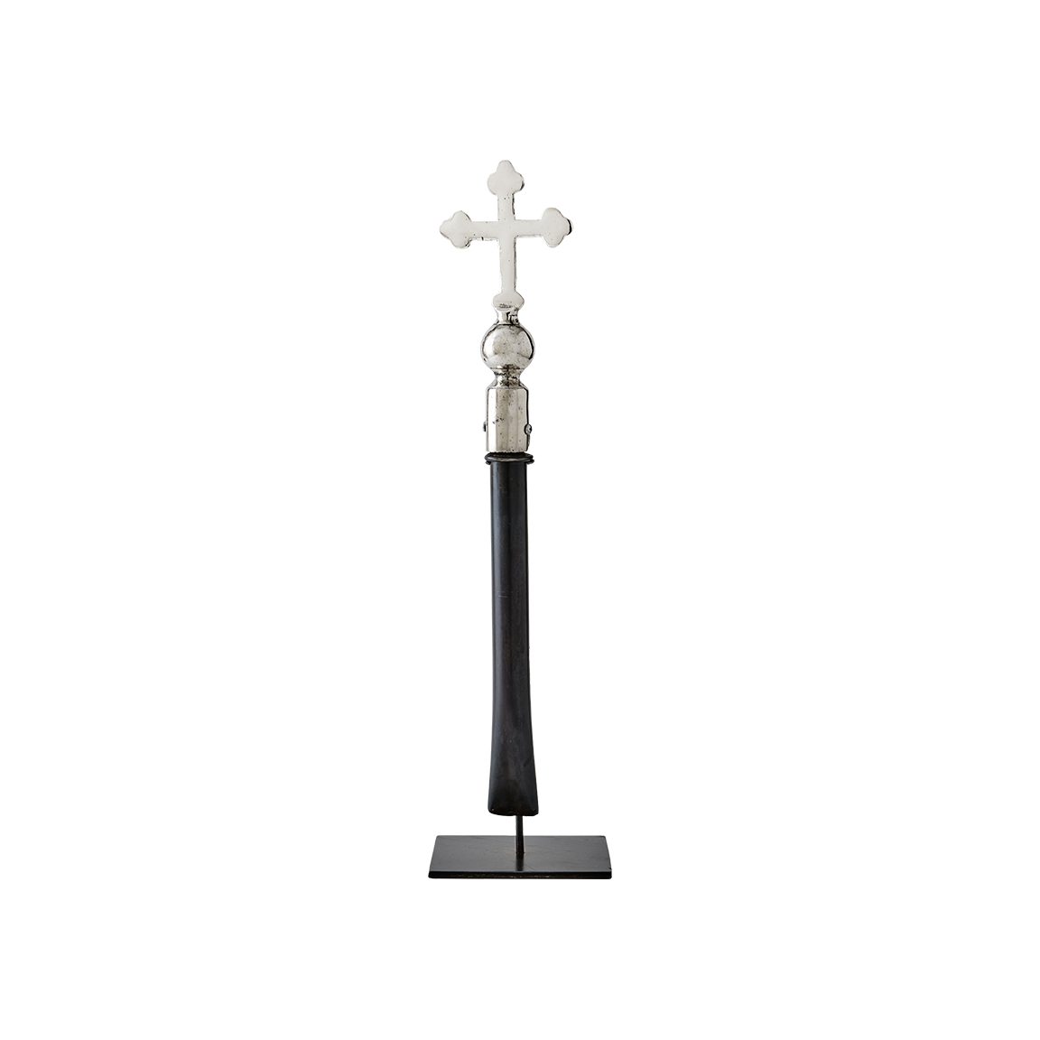 A nickel plated cross with natural iron handle supported on a gallery stand.