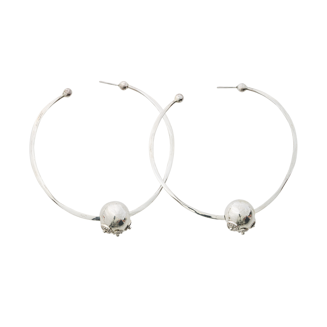 Two simple  earring hoops with a silver bead. Plain background.