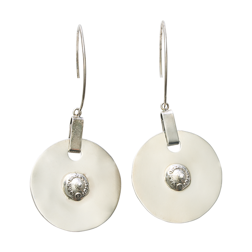 A pair of silver drop earrings featuring circular discs with raised decorative studs in the center.