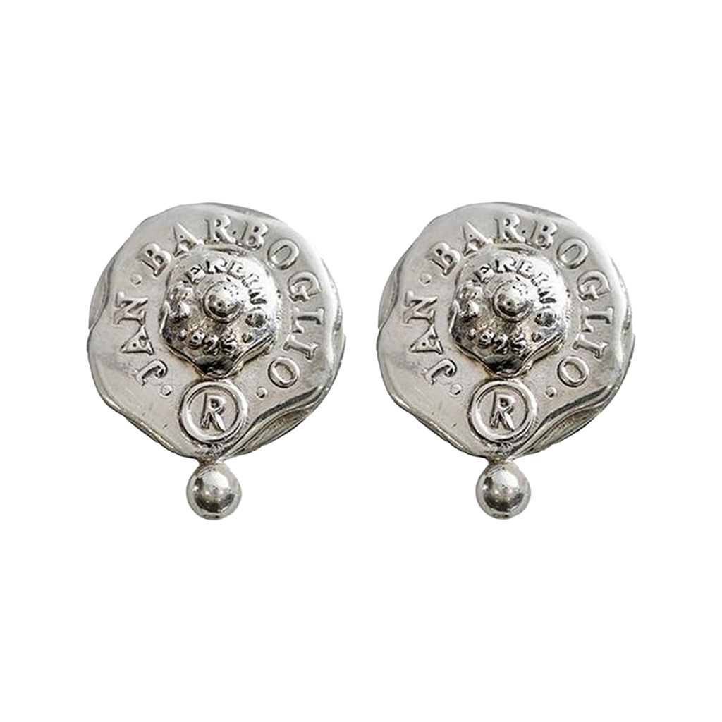 Silver earrings with a seal. The seals says thee name of the designer and place of origin. A small silver bead in under the seal.