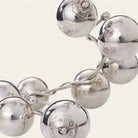 Big silver beads with engraved signature seals. Simple background.
