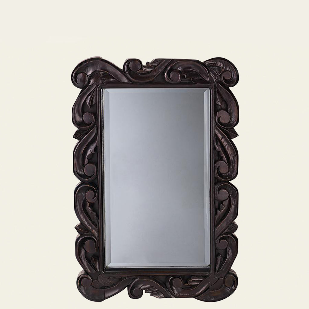 A wood mirror with hand carved scroll detail and 1 1/2