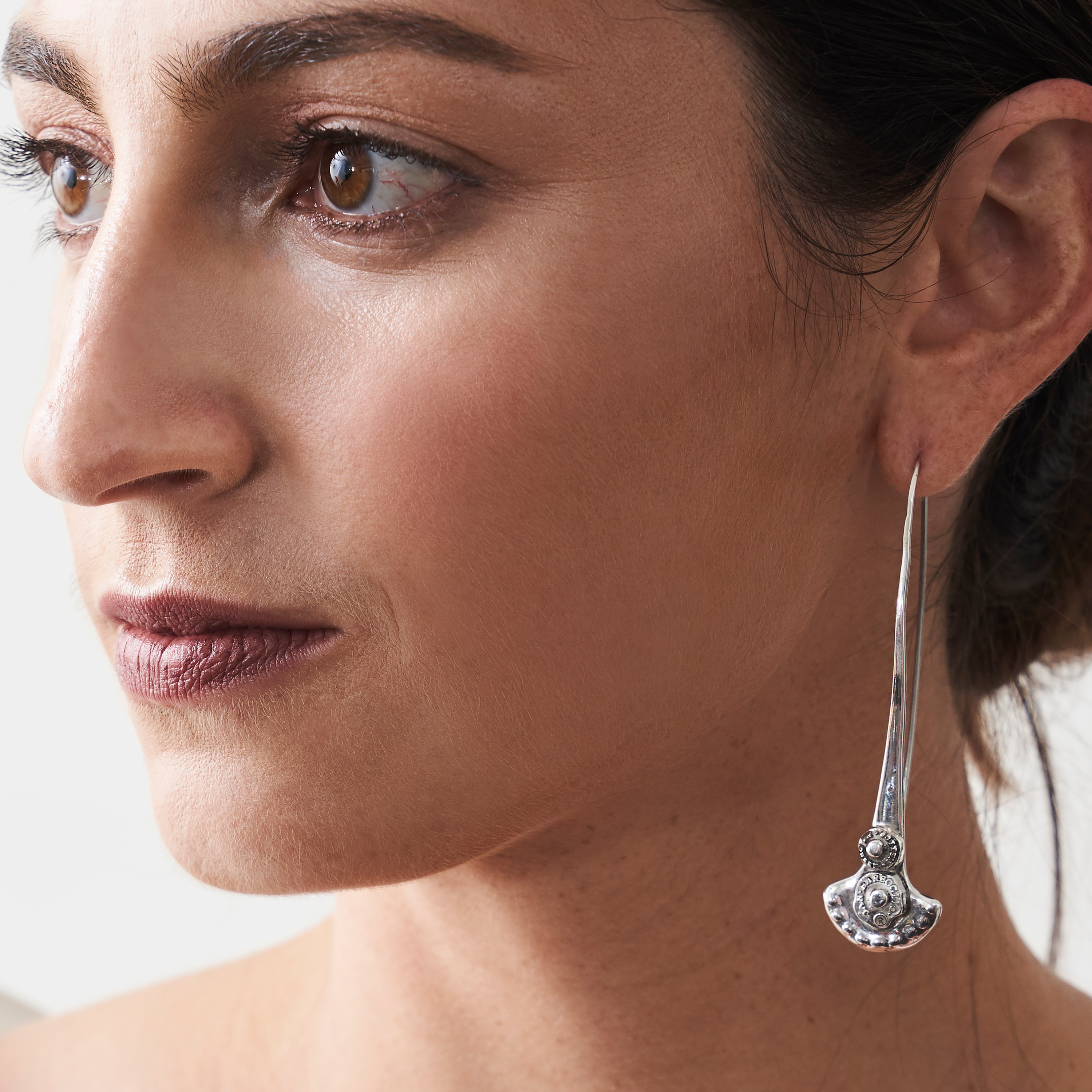 Woman wearing a silver hook earring